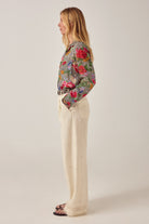 ELSHAM BOUTIQUE Otto ivory cotton-linen straight-leg pants with front pleats and embroidered hem, side profile view