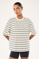 ELSHAM BOUTIQUE oversized Spark tee in whisper white with black horizontal stripes and a small chest branding patch.