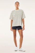 Model wearing ELSHAM BOUTIQUE oversized whisper white striped t-shirt with black shorts and white sneakers