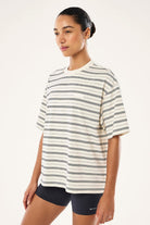 ELSHAM BOUTIQUE oversized white t-shirt with thin black horizontal stripes and a small chest branding patch