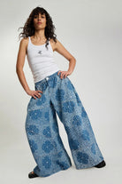 Model wearing ELSHAM BOUTIQUE Daddios low waist super wide leg denim jeans in Aegean paisley blue with front seams.