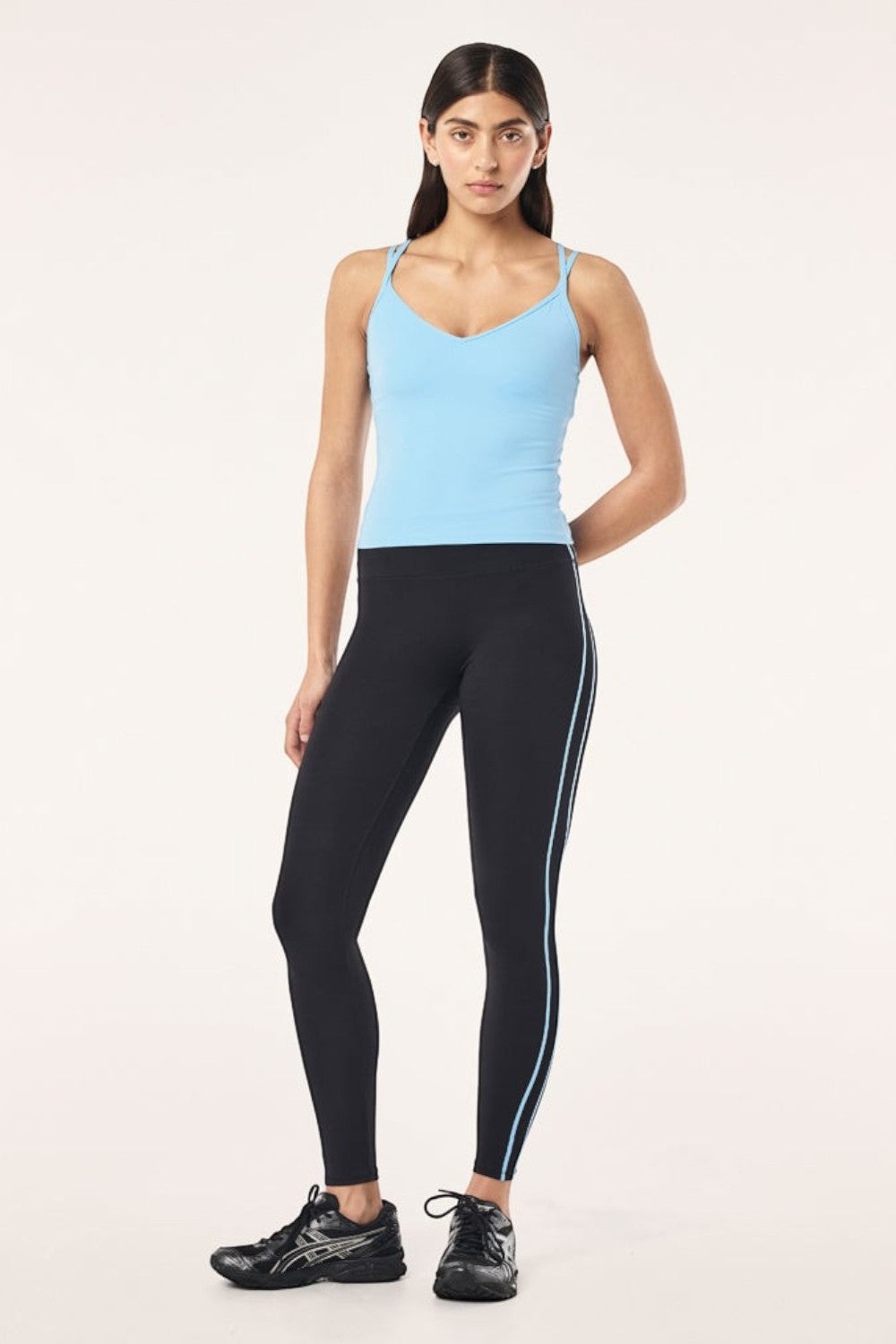 Model wearing ELSHAM BOUTIQUE Paramount Tank in Alaskan Blue with scoop neck and double straps, paired with leggings.
