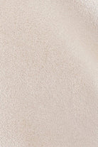 Close-up of the shimmering pearl-toned vegan leather texture on the ELSHAM BOUTIQUE Marina Pearl Clutch.