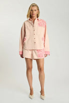 Model wearing ELSHAM BOUTIQUE pink petal oversized cotton denim shacket with frayed edges and matching denim shorts