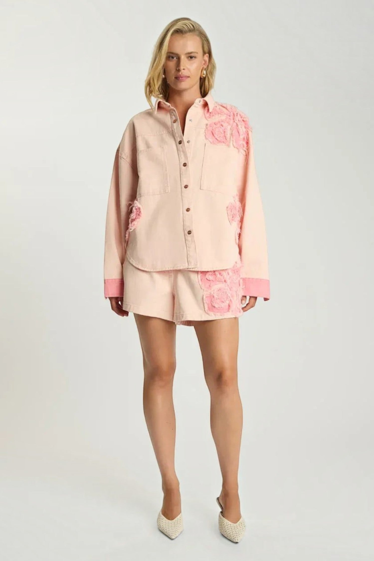 Model wearing ELSHAM BOUTIQUE pink petal oversized cotton denim shacket with frayed edges and matching denim shorts