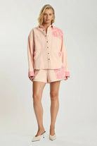 Model wearing ELSHAM BOUTIQUE pink petal oversized cotton denim shacket with frayed edges and matching shorts