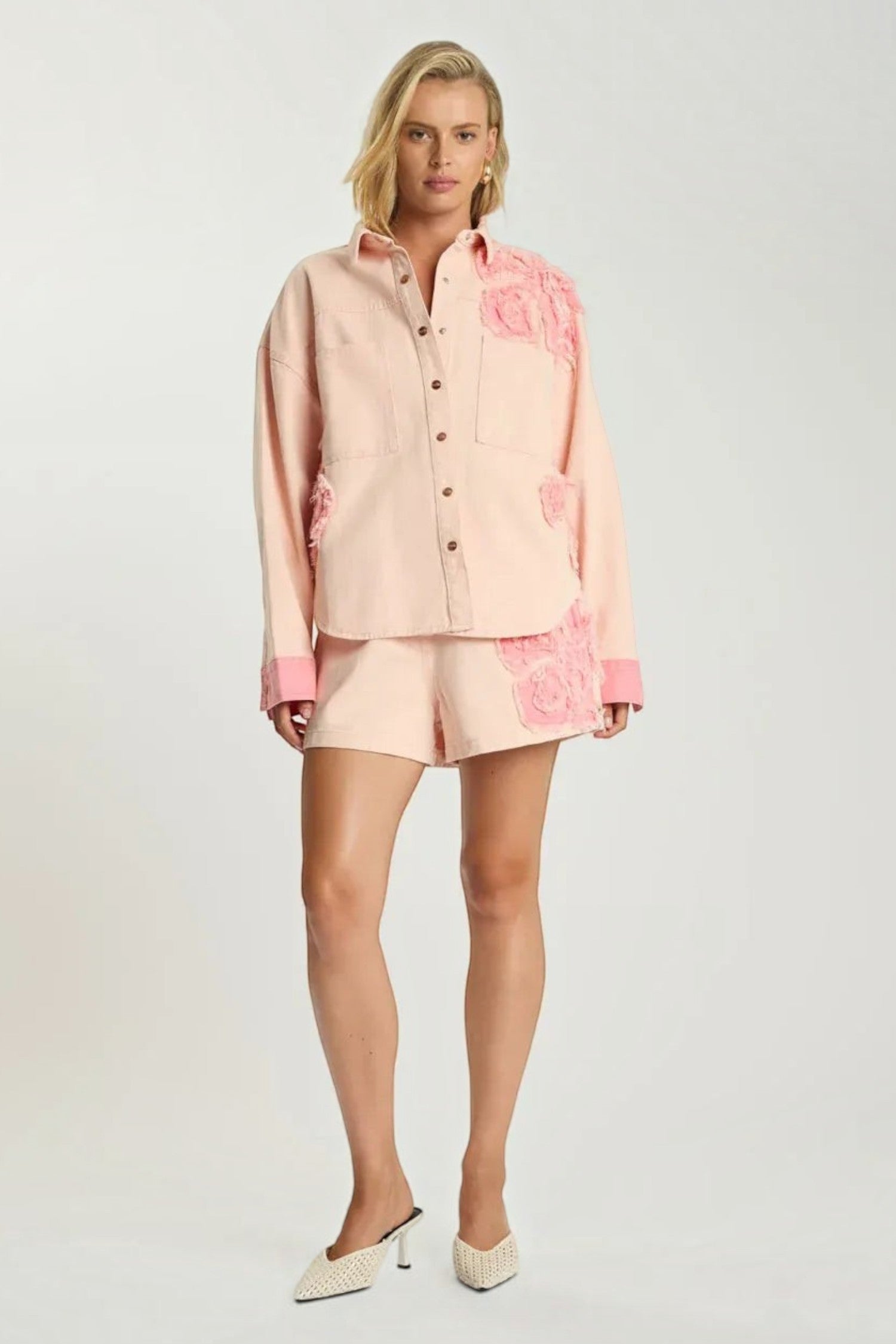 Model wearing ELSHAM BOUTIQUE pink petal oversized cotton denim shacket with frayed edges and matching shorts