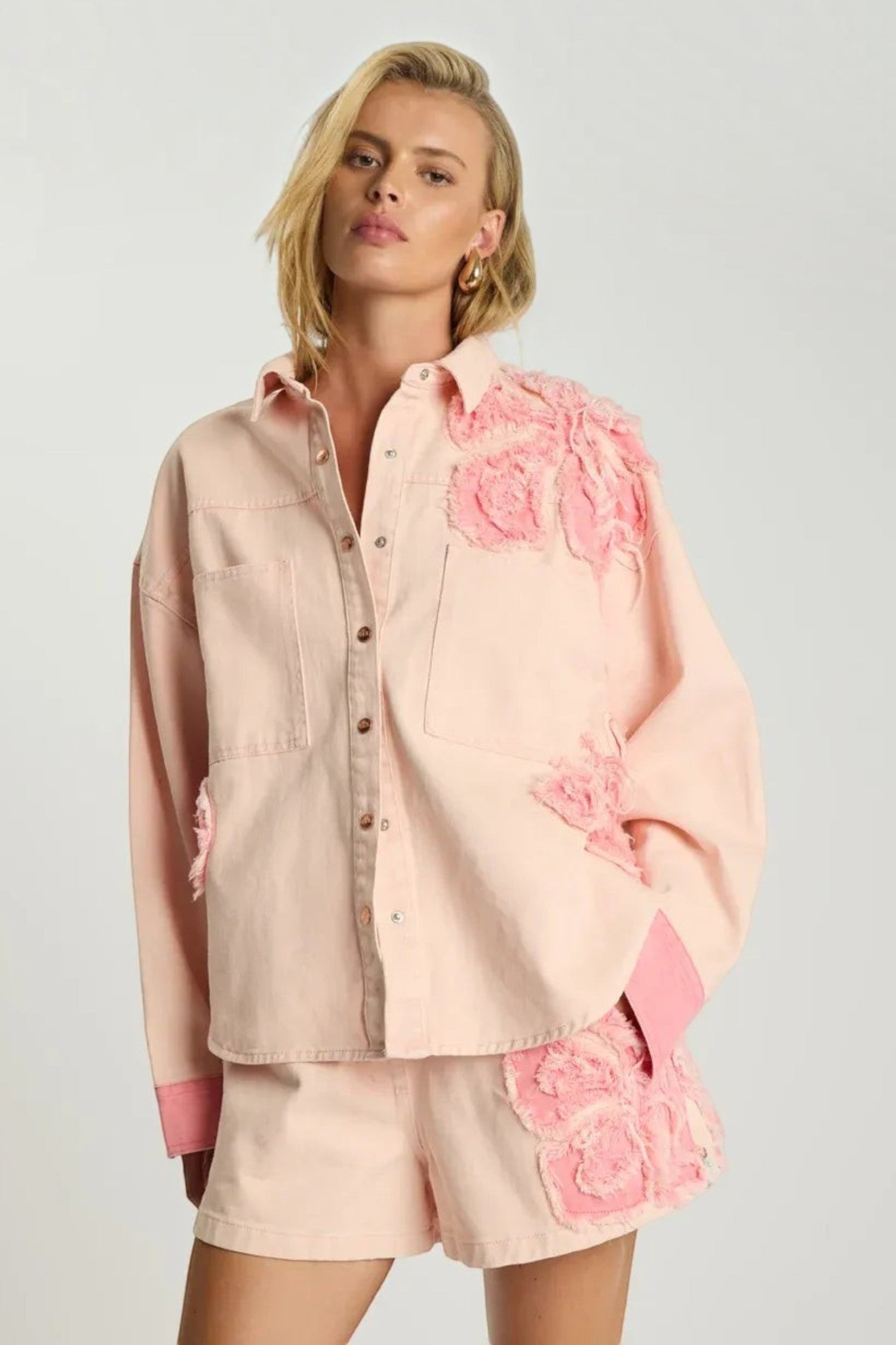 ELSHAM BOUTIQUE pink petal oversized cotton denim shacket with frayed floral applique details and button-up front