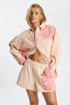 ELSHAM BOUTIQUE model wearing pink petal high-waisted elasticated denim shorts with matching embroidered denim shirt