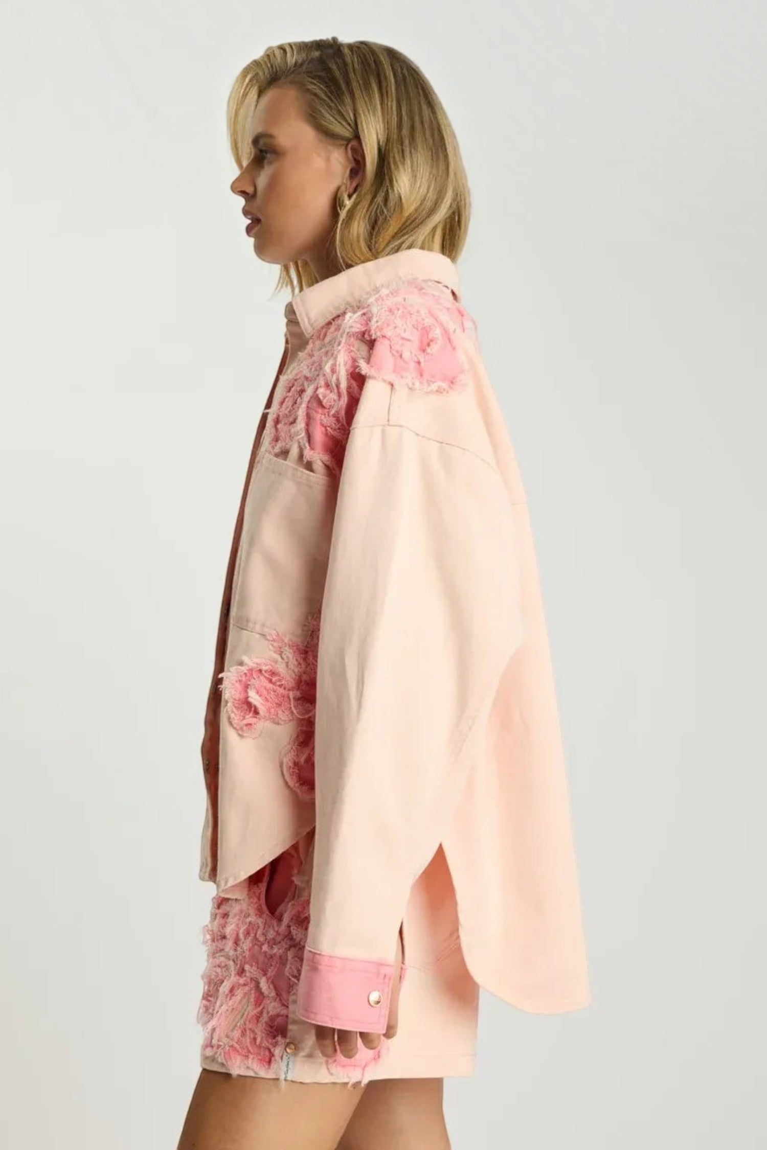 ELSHAM BOUTIQUE pink petal oversized denim shacket with frayed detailing worn by a blonde model, side view