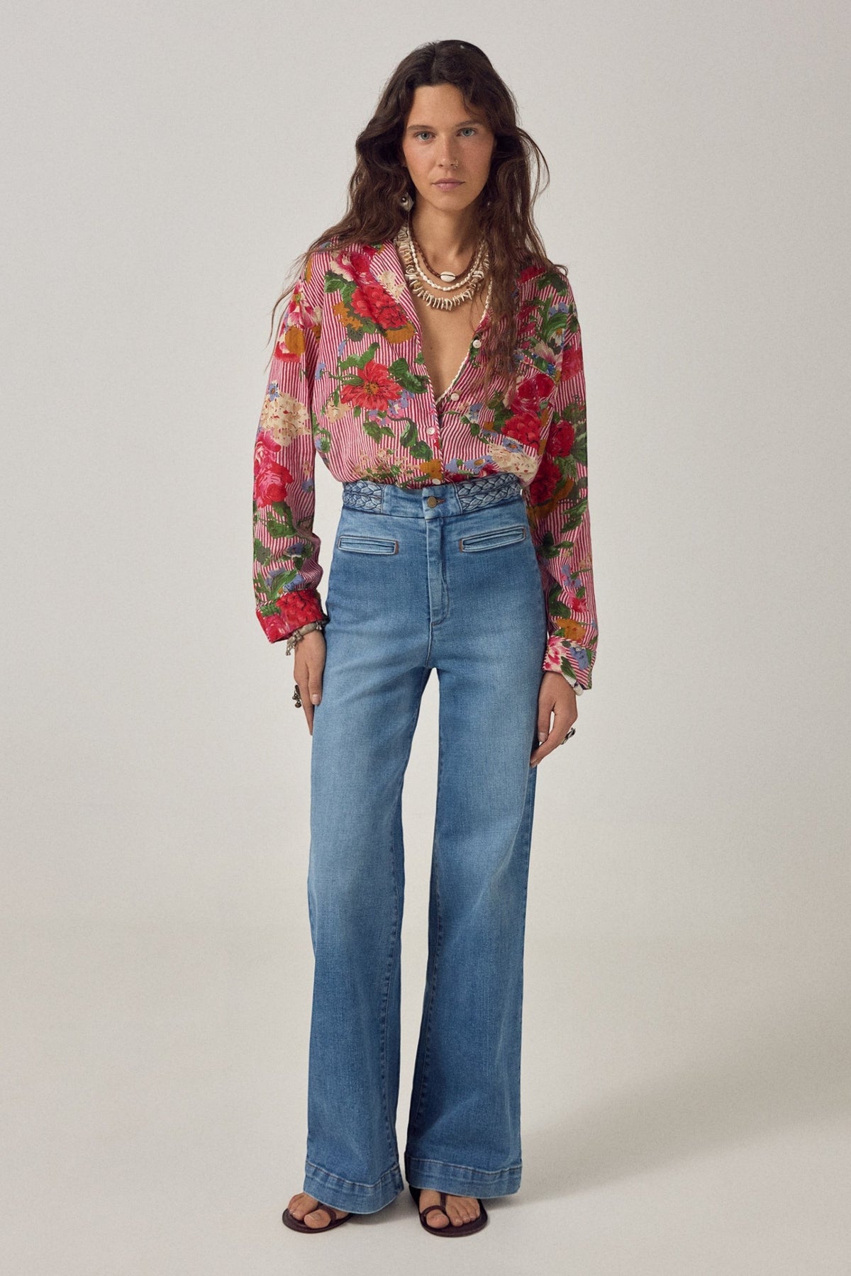 ELSHAM BOUTIQUE Piti shirt in rouge floral print cotton with stripes, worn with wide-leg blue jeans by a model.