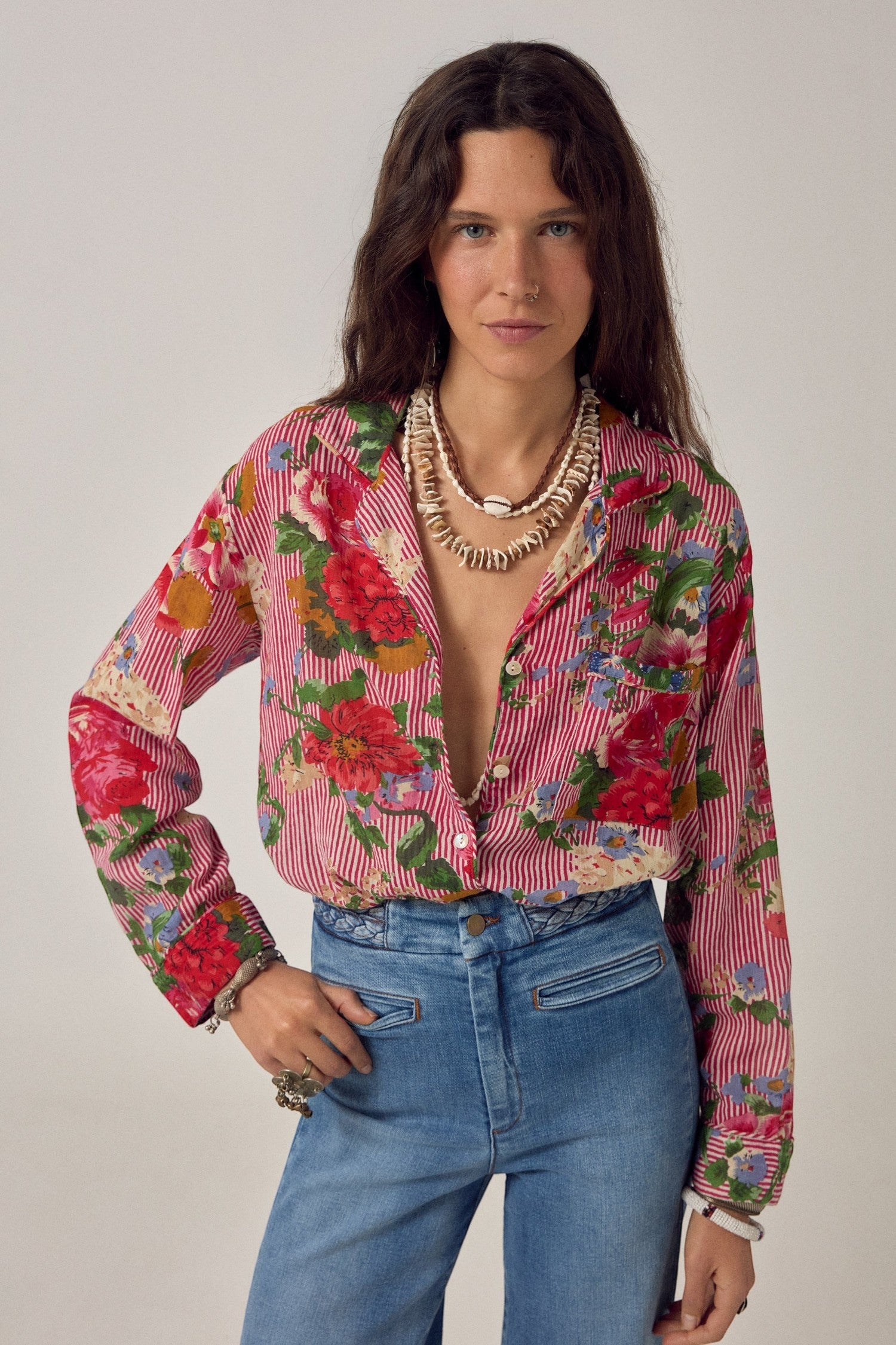 ELSHAM BOUTIQUE Piti shirt in rouge cotton with bold floral print and fine stripes, worn with blue denim jeans