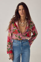 ELSHAM BOUTIQUE Piti shirt in rouge featuring a floral print over fine stripes, worn with blue jeans.