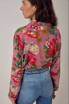 ELSHAM BOUTIQUE Piti shirt in rouge floral print over fine stripes, worn tucked into blue jeans, back view.