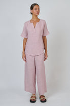 Model wearing ELSHAM BOUTIQUE radish pink linen GA718 split V-neck top and matching wide-leg trousers