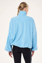 ELSHAM BOUTIQUE Alaskan Blue Radius Jacket with funnel neck, oversized fit, and adjustable hem drawcord, back view.
