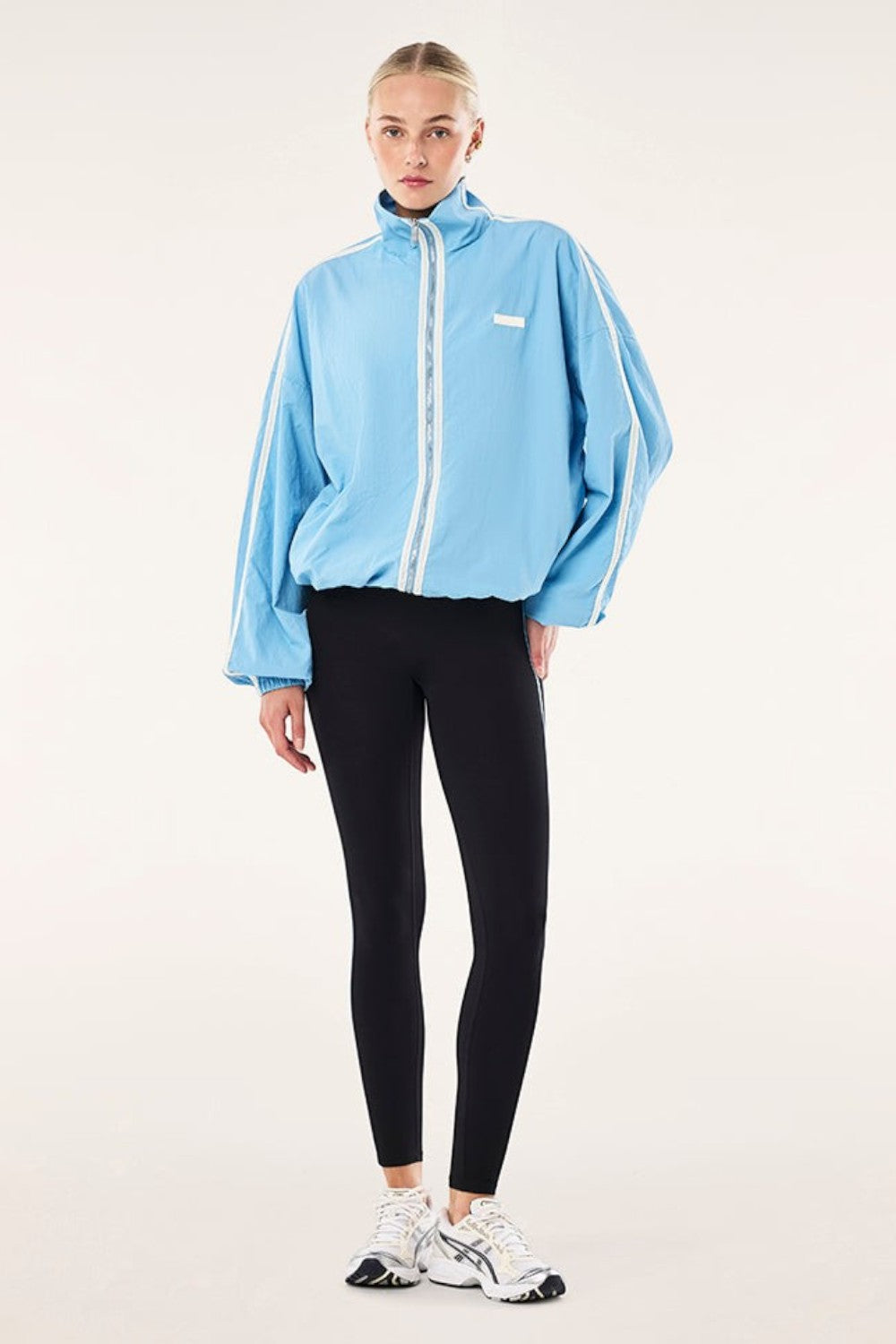 ELSHAM BOUTIQUE Radius Jacket in Alaskan Blue with funnel neck, side stripe detail, and adjustable hem drawcord.