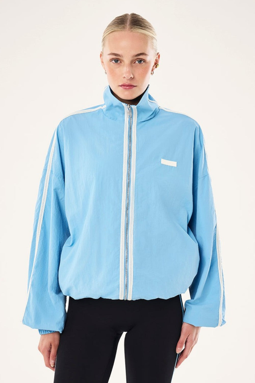 ELSHAM BOUTIQUE Radius Jacket in Alaskan Blue with funnel neck, white side stripe detail, and oversized fit.