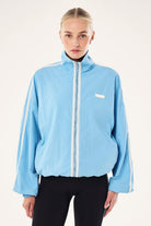 ELSHAM BOUTIQUE Radius Jacket in Alaskan Blue with funnel neck, white side stripe detail, and oversized fit.