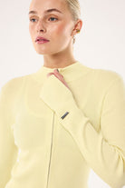 ELSHAM BOUTIQUE Solar Knit Jacket in soft yellow featuring a high neck, rib knit texture, and double end zipper.