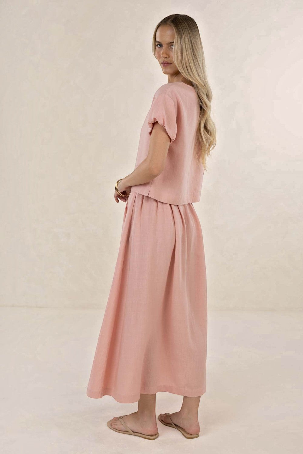ELSHAM BOUTIQUE Solar Skirt in musk pink linen-tencel blend, featuring an A-line midi silhouette and side pockets.