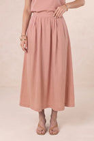 ELSHAM BOUTIQUE Solar Skirt in musk pink linen-tencel blend, featuring an A-line midi silhouette and side pockets.