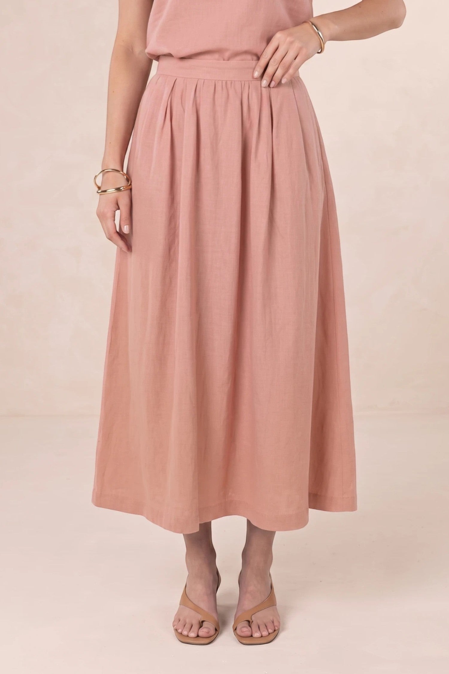 ELSHAM BOUTIQUE Solar Skirt in musk pink linen-tencel blend, featuring an A-line midi silhouette and side pockets.