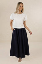 ELSHAM BOUTIQUE Solar Skirt in navy linen-tencel blend featuring an A-line midi silhouette and deep side pockets.