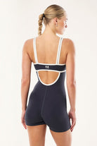 ELSHAM BOUTIQUE Solis playsuit in marine blue and black with a square neck and open back detail, back view.