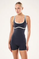 ELSHAM BOUTIQUE Solis playsuit in marine blue and black with a square neck, adjustable straps, and bike short length.