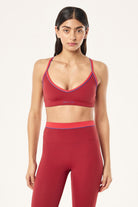 ELSHAM BOUTIQUE Spectrum sports bra in cherry and strawberry red with a V-neck, cross back, and contrast binding.
