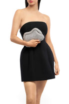 ELSHAM BOUTIQUE Taylor silver metallic crochet clutch held by a model in a black strapless dress
