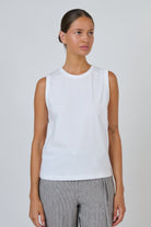 ELSHAM BOUTIQUE white cotton sleeveless muscle top with a round crew neckline worn by a model