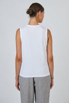 Back view of ELSHAM BOUTIQUE white cotton sleeveless muscle top with a round neckline on a model