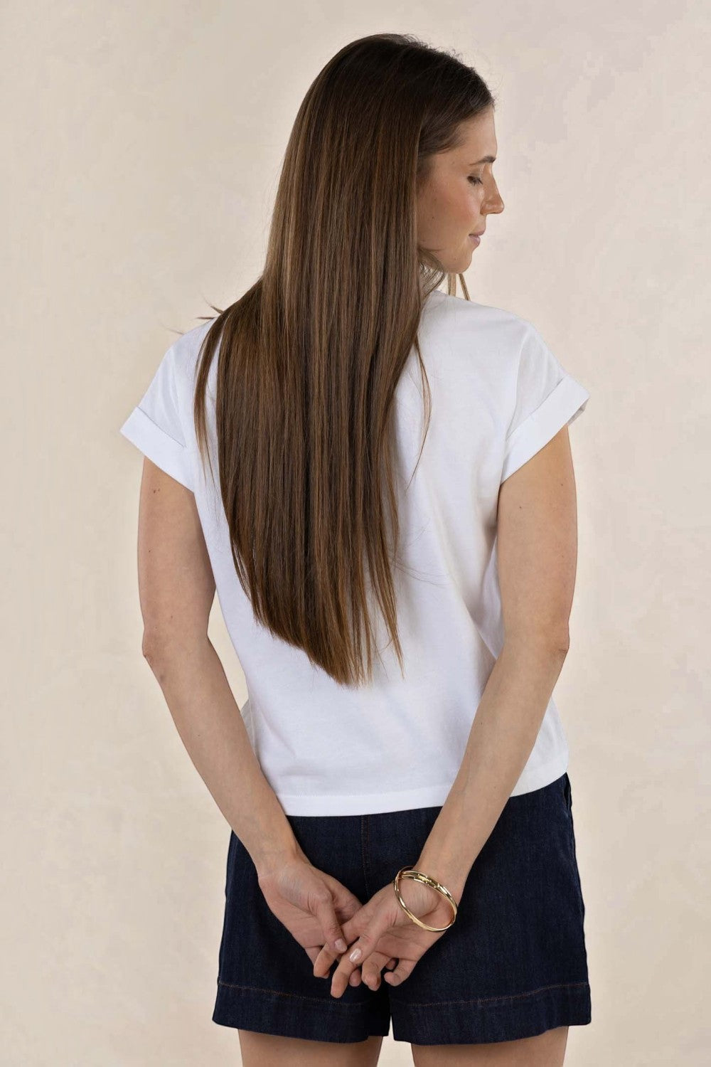 ELSHAM BOUTIQUE white cotton crew neck tee with rolled sleeves worn by a woman from the back view