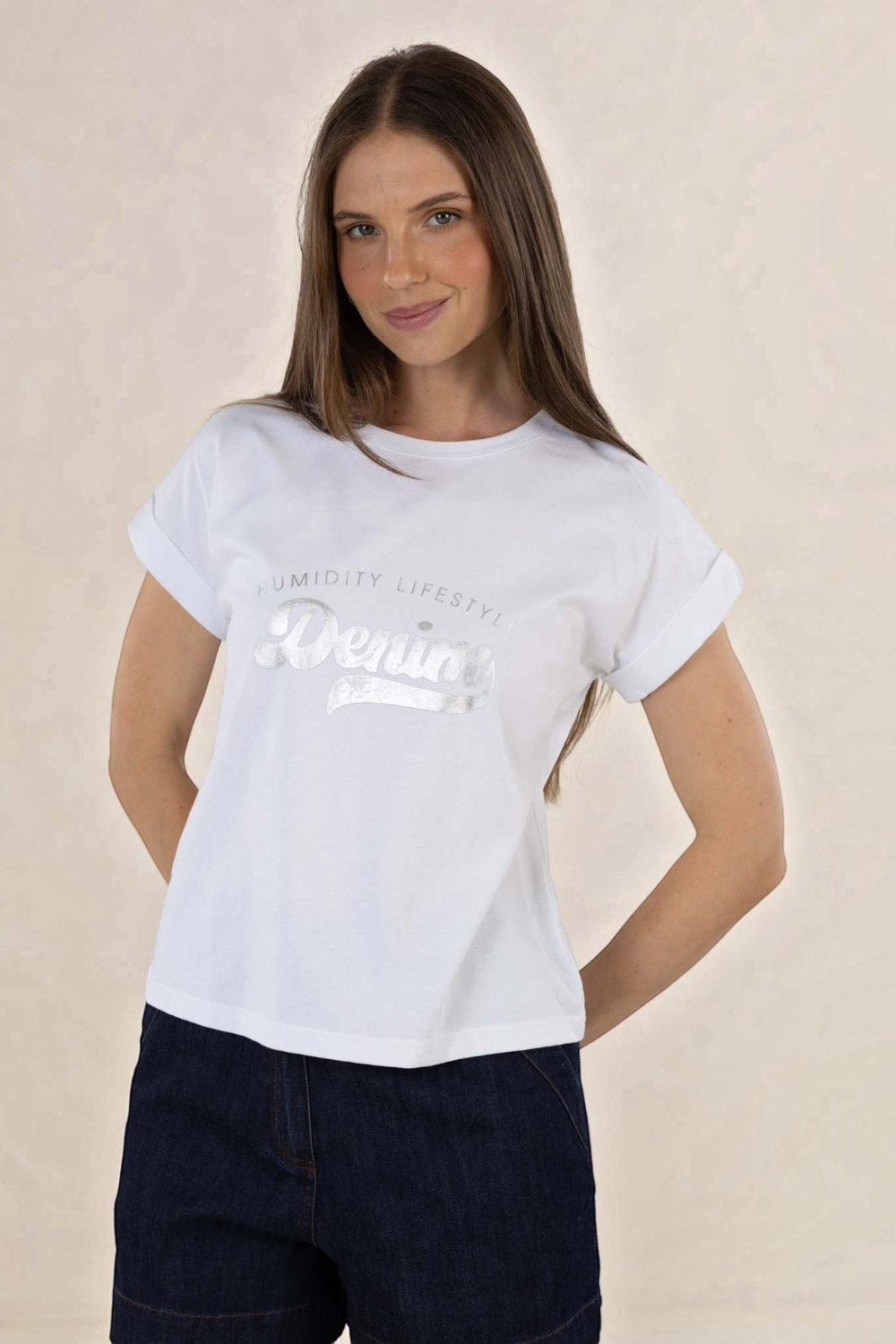 Model wearing an ELSHAM BOUTIQUE white cotton crew neck tee with rolled sleeves and a silver glitter logo print.