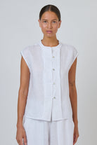 ELSHAM BOUTIQUE white linen sleeveless top with a collarless neckline and quilted button-through placket.