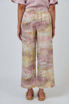 Back view of ELSHAM BOUTIQUE GA398 wide-leg linen trousers in a multi-coloured abstract print with gathered waistband.
