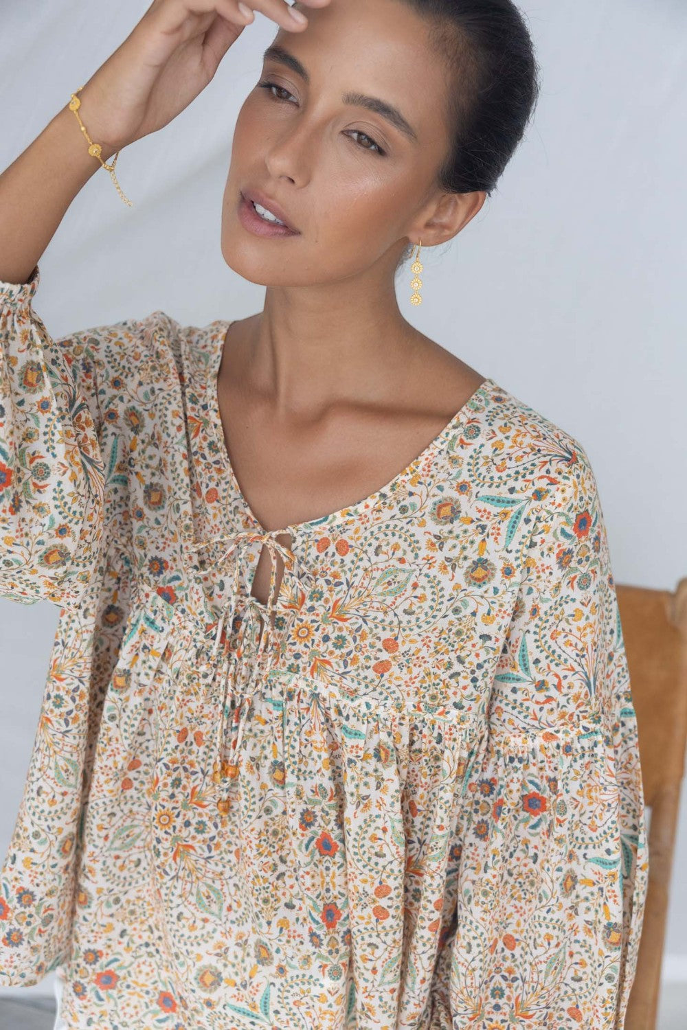 ELSHAM BOUTIQUE Yasmin midi dress in almond floral print with V-neckline and tiered frill details on a model