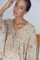 ELSHAM BOUTIQUE Yasmin midi dress in almond floral print with V-neckline and tiered frill details on a model