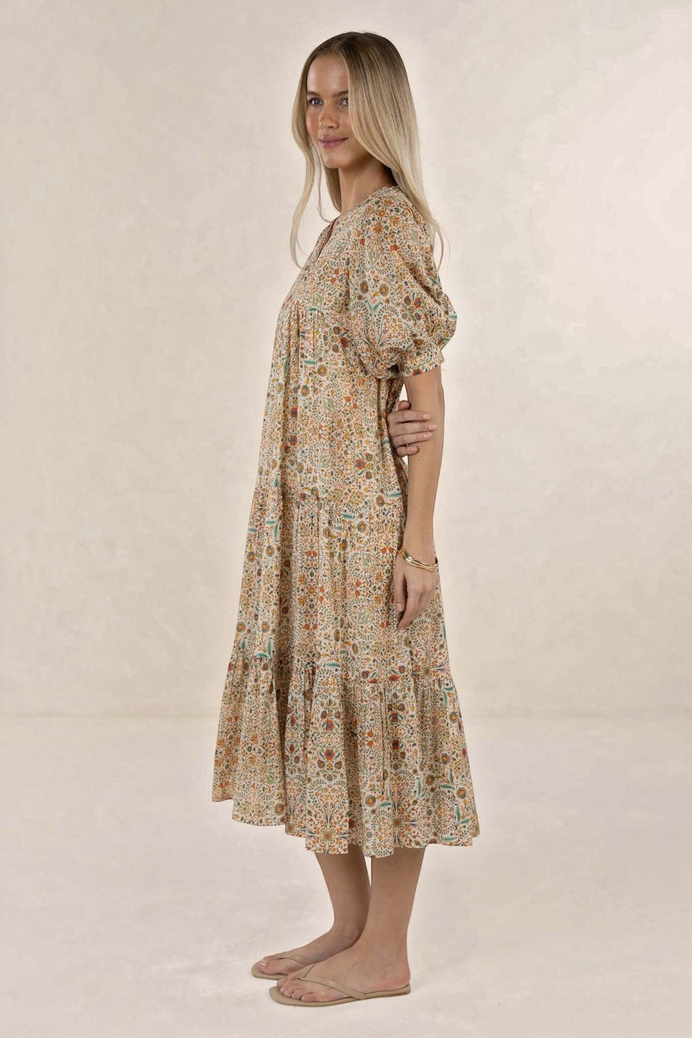 ELSHAM BOUTIQUE Yasmin midi dress in almond floral print with tiered frills, short sleeves, and V-neckline.