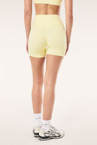 ELSHAM BOUTIQUE soft yellow 5-inch bike shorts with a high-rise V-waistband and peached Studio Soft fabric back view