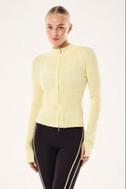 ELSHAM BOUTIQUE soft yellow rib knit zip-up jacket with high neck and long sleeves worn by a model