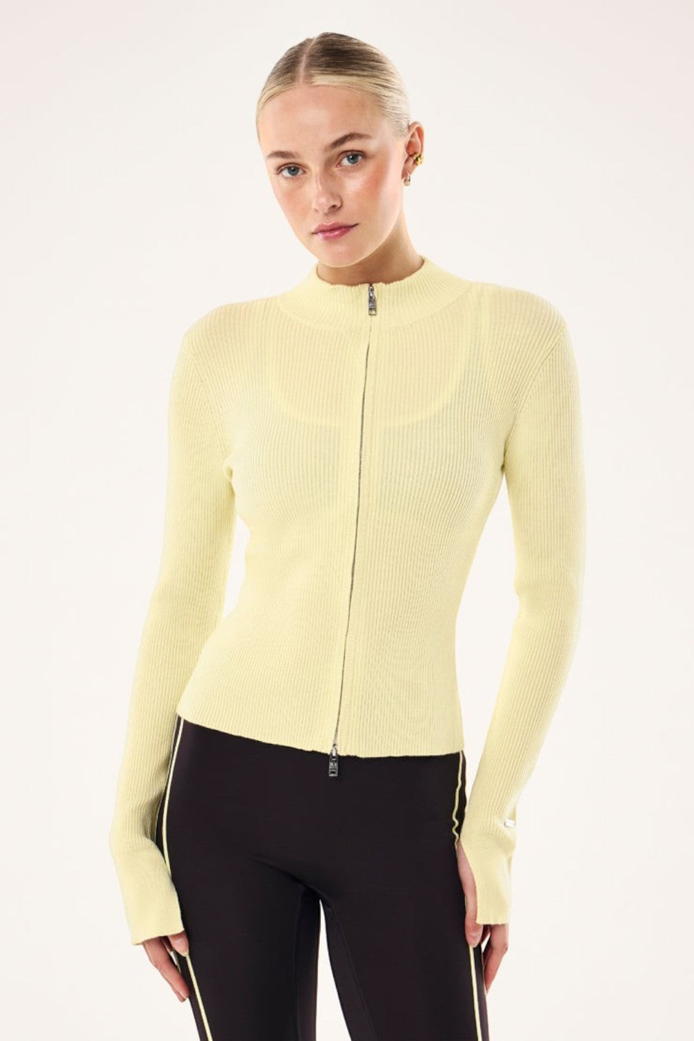 ELSHAM BOUTIQUE soft yellow rib knit zip-up jacket with high neck and long sleeves worn by a model.