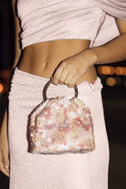 ELSHAM BOUTIQUE Alfie blush floral sequin bag with double ring handles and gold tone hardware. Magnetic closure.